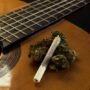 Marijuana buds and joint on a guitar