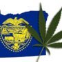 Torn Oregon flag with marijuana leaf