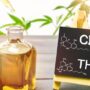 Cannabis oil in bottle and chalkboard with molecule drawing of THC and CBD.