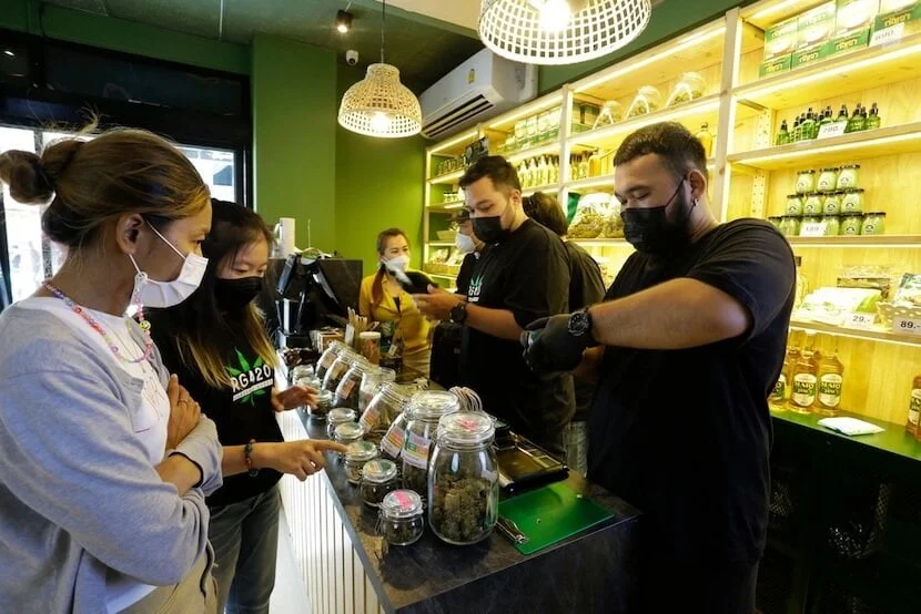 Managers and budtenders at a dispensary, working hard during a dispensary rush.