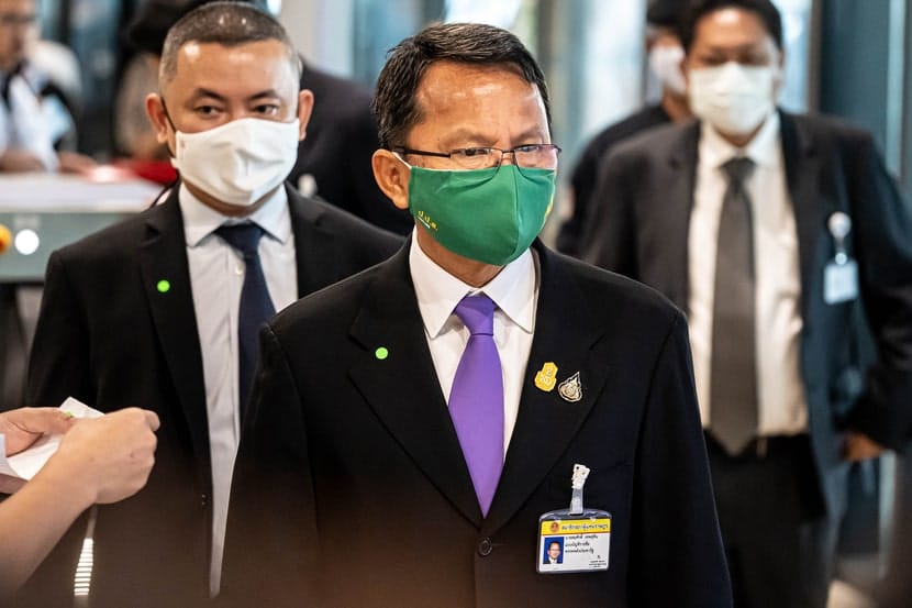 Public Health Minister of Thailand, Somsak Thepsutin, wearing a green face mask and suit.