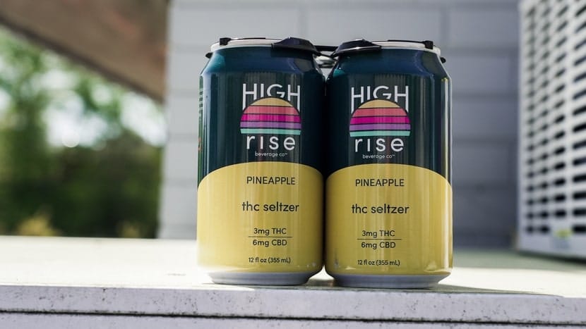 Two cans of THC-infused seltzer displayed outdoors, representing cannabis drinks as a modern alternative to alcohol.