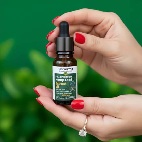 Cannarma CBD oil being held by pretty hands