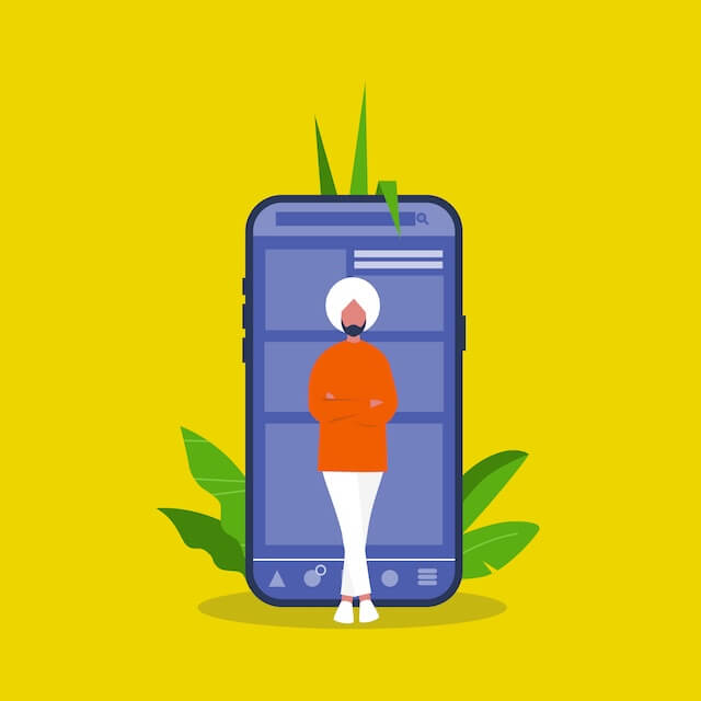 Indian man leaning on a mobile phone