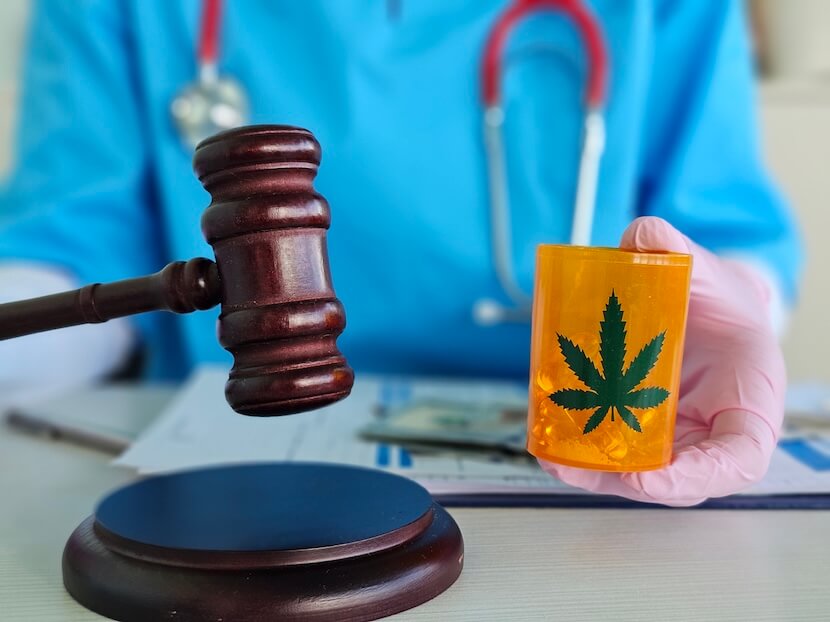 Healthcare worker holding a container of medicinal cannabis and a gavel