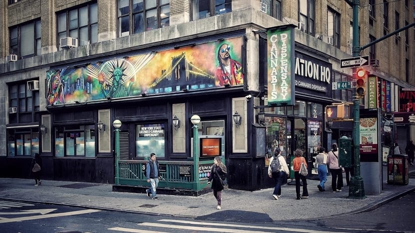 colorful dispensary signage on a busy street in Manhattan