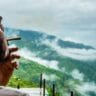 Young man smoking a weed joint in the Himalayan hills
